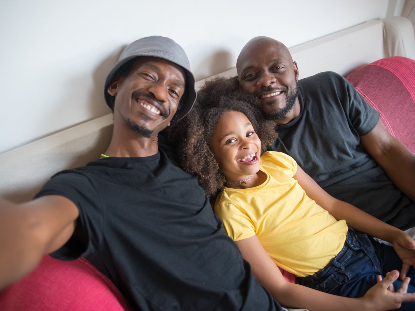 A family relaxes together at home, sharing a warm and joyful moment.